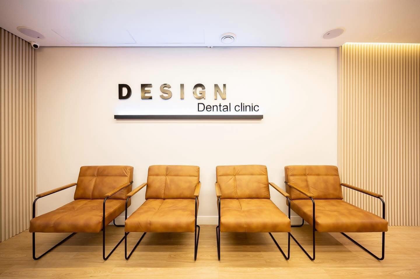 Sala de espera com poltronas de couro e o logo da clínica